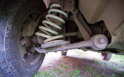 Broken spring in the car suspension system.